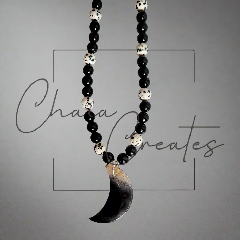 Black & Clear Druzy Agate Moon Pendant on Dalmatian Jasper and Onyx Beaded Necklace ©2024 Chaia Creates. All rights reserved. Unauthorized use or duplication of this content is prohibited.