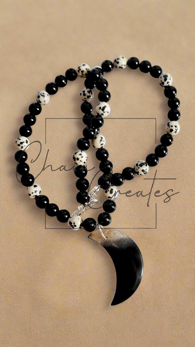 Black & Clear Druzy Agate Moon Pendant on Dalmatian Jasper and Onyx Beaded Necklace ©2024 Chaia Creates. All rights reserved. Unauthorized use or duplication of this content is prohibited.