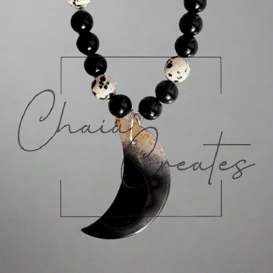 Black & Clear Druzy Agate Moon Pendant on Dalmatian Jasper and Onyx Beaded Necklace ©2024 Chaia Creates. All rights reserved. Unauthorized use or duplication of this content is prohibited.