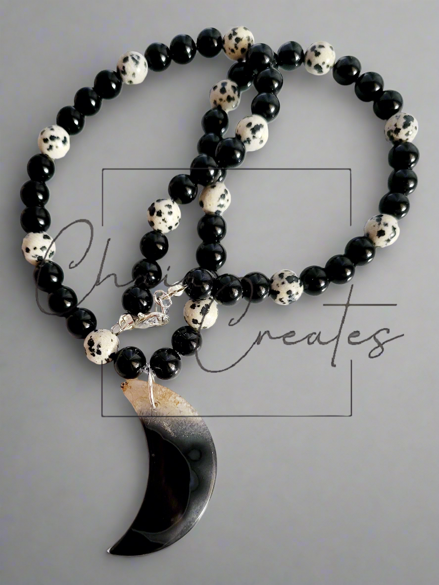 Black & Clear Druzy Agate Moon Pendant on Dalmatian Jasper and Onyx Beaded Necklace ©2024 Chaia Creates. All rights reserved. Unauthorized use or duplication of this content is prohibited.